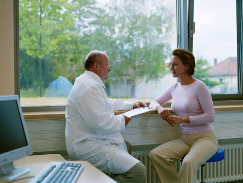 A woman having a consultation with an oral surgeon