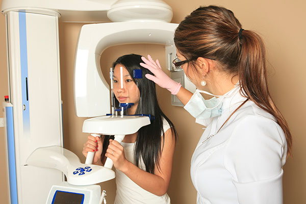 Patient being scanned by 3D cone beam scanner from Surprise Oral & Implant Surgery in Surprise, AZ