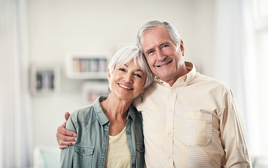 Senior couple smiling and hugging because of their zygomatic implants from Surprise Oral & Implant Surgery in Surprise, AZ