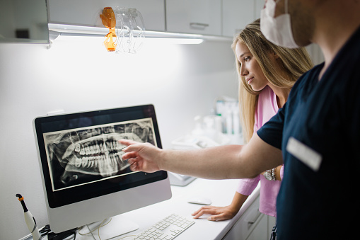 Woman looking at her x-ray at Surprise Oral & Implant Surgery in Surprise, AZ