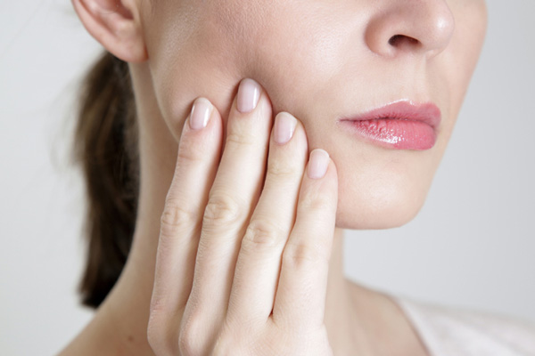 Close up of a woman with dental pain and trauma at Surprise Oral & Implant Surgery in Surprise, AZ