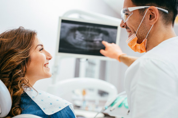 Woman patient smiling with a dental professional.