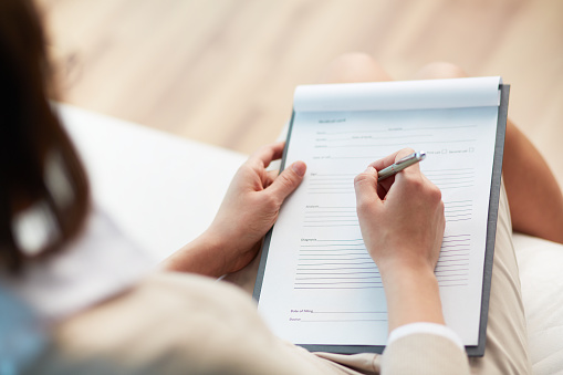 A person filling out a referral form